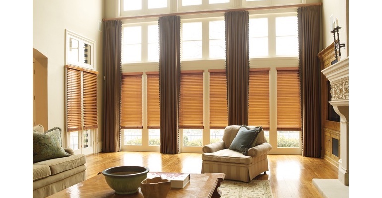 Minneapolis great room with natural wood blinds and full-length draperies.